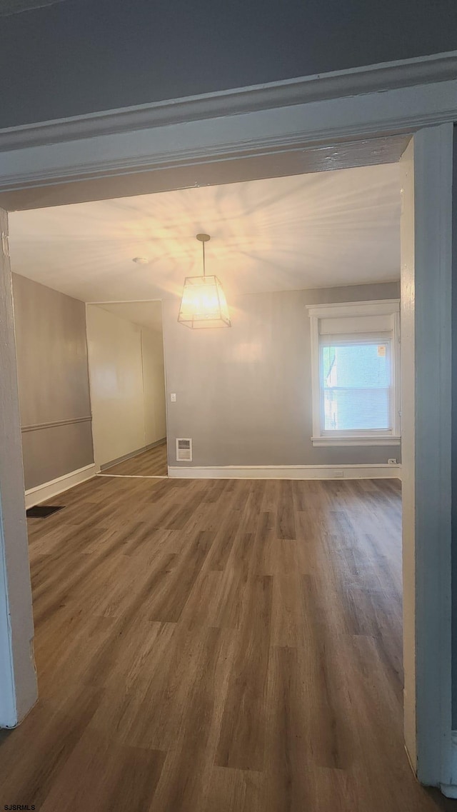 unfurnished room with dark wood-type flooring