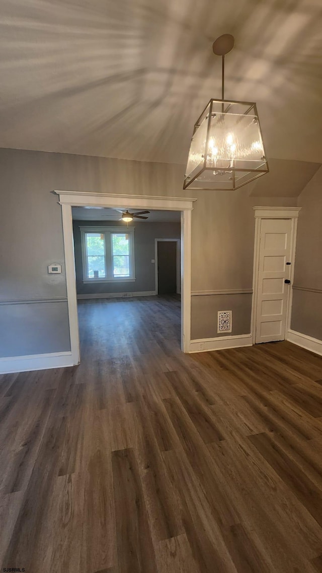 unfurnished dining area with ceiling fan and dark hardwood / wood-style flooring