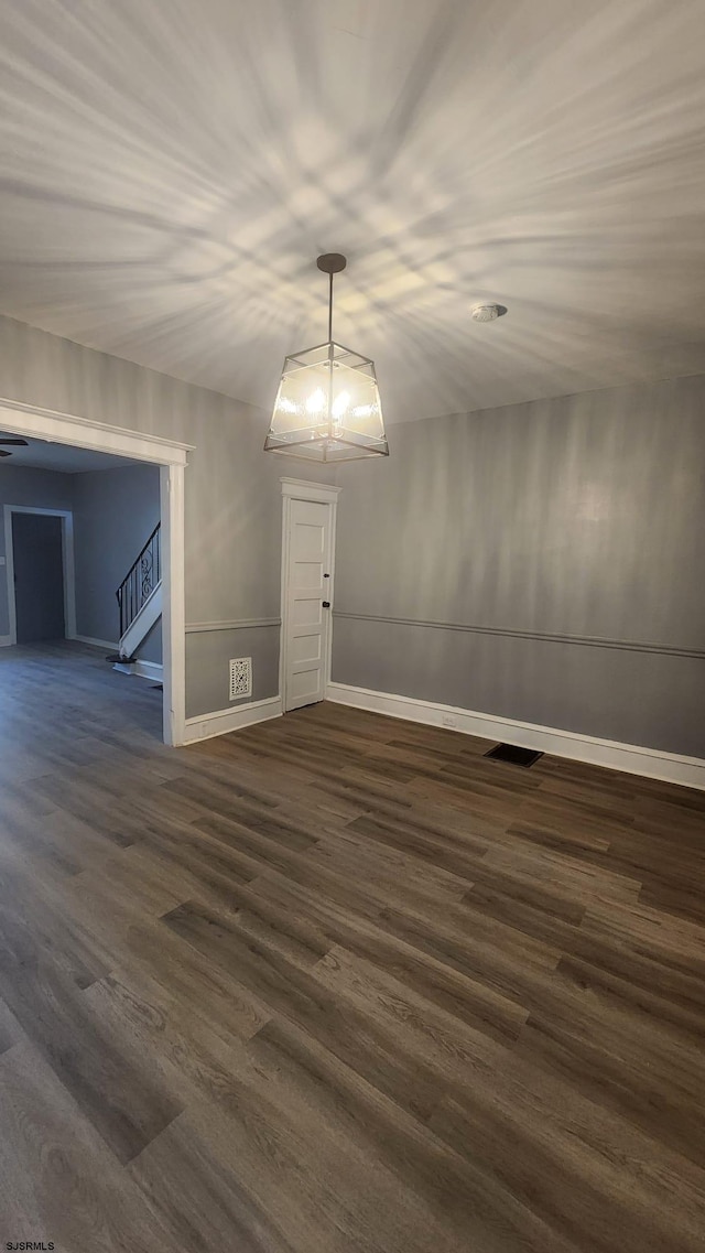 empty room with dark hardwood / wood-style flooring