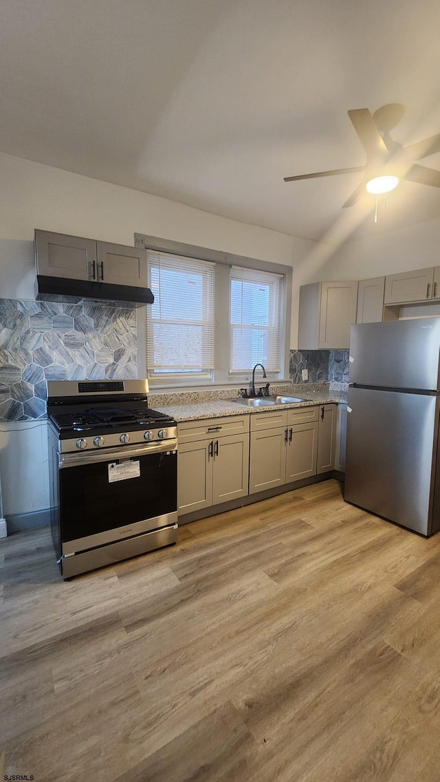 kitchen featuring gray cabinetry, appliances with stainless steel finishes, sink, and light wood-type flooring