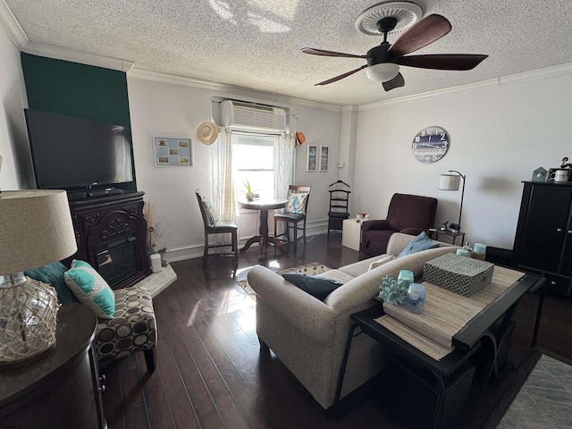 living room featuring dark wood-type flooring, ornamental molding, and an AC wall unit