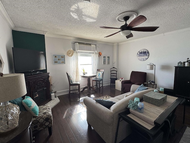 living room featuring crown molding, dark hardwood / wood-style flooring, a wall unit AC, and a textured ceiling