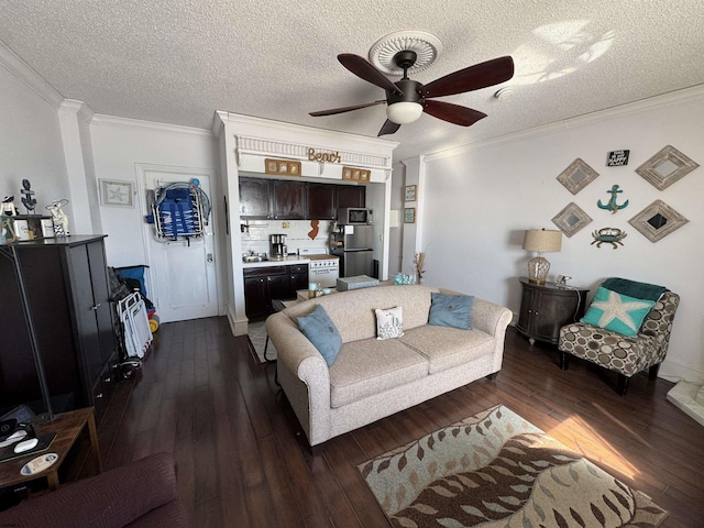 living room with dark hardwood / wood-style flooring, ceiling fan, crown molding, and a textured ceiling