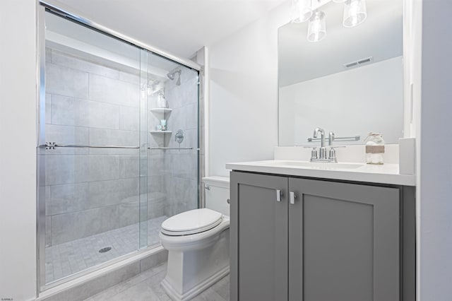 bathroom featuring vanity, an enclosed shower, tile patterned floors, and toilet