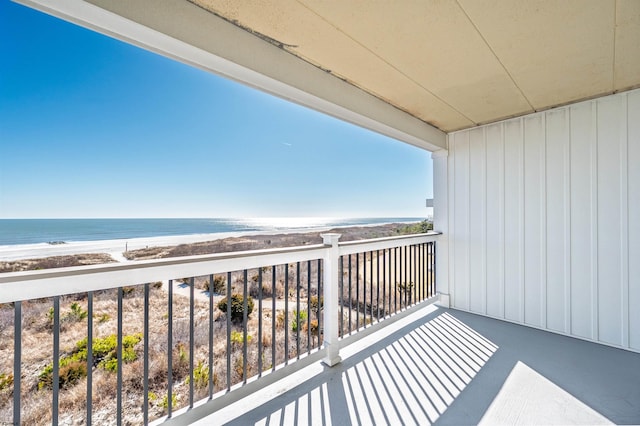 balcony featuring a water view and a beach view