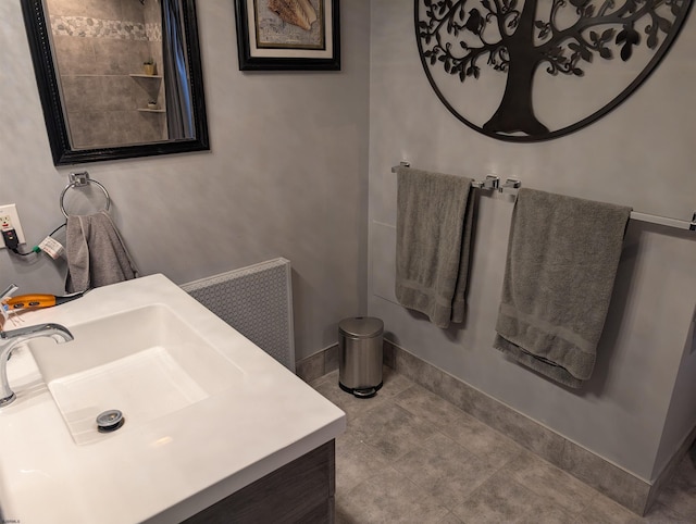 bathroom featuring radiator heating unit, tile patterned flooring, and vanity