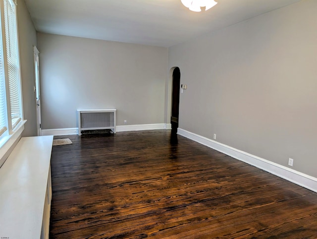 spare room with dark wood-type flooring