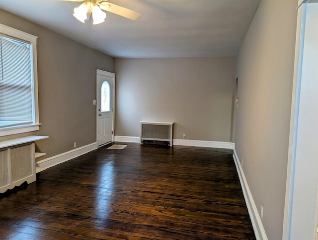 foyer entrance featuring dark wood-type flooring and ceiling fan