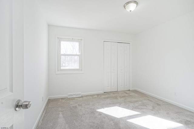 unfurnished bedroom featuring a closet and carpet flooring