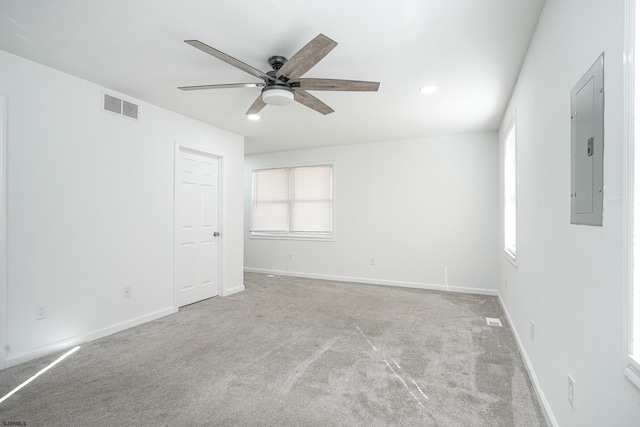 carpeted spare room featuring electric panel and ceiling fan