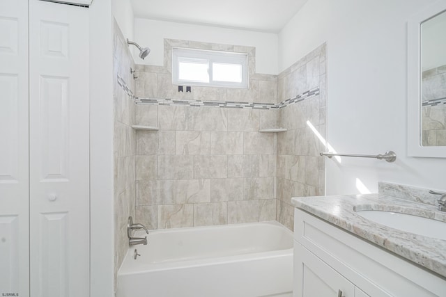 bathroom featuring vanity and tiled shower / bath combo