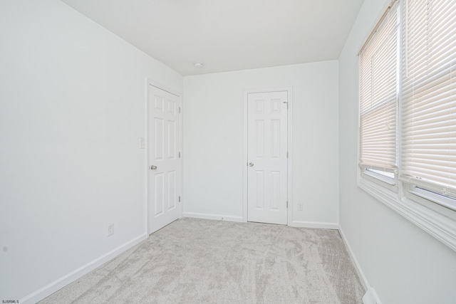 unfurnished bedroom with light colored carpet