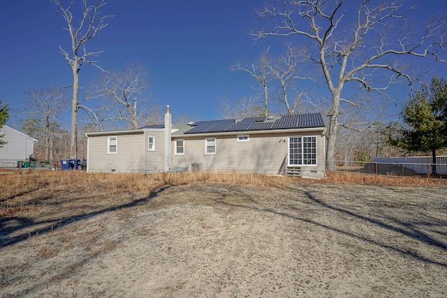 rear view of house with solar panels