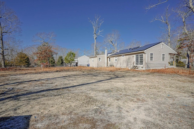 rear view of house with solar panels