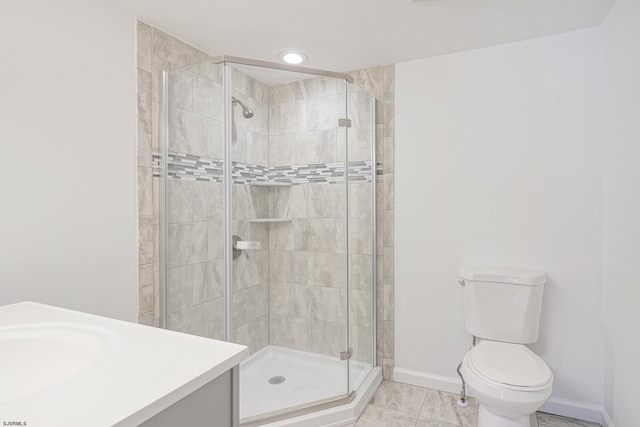 bathroom with toilet, a shower with door, and vanity