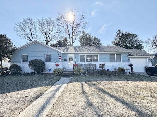 single story home featuring a garage and a front yard