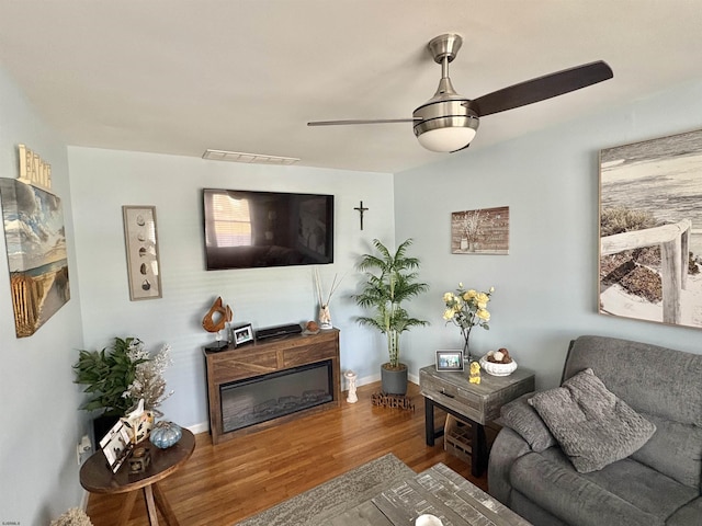 living room with hardwood / wood-style flooring and ceiling fan