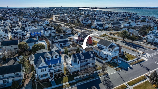 drone / aerial view with a residential view and a water view