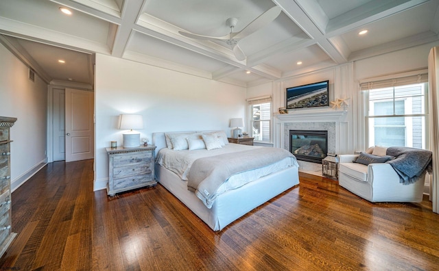 bedroom with coffered ceiling, dark wood-type flooring, and beam ceiling