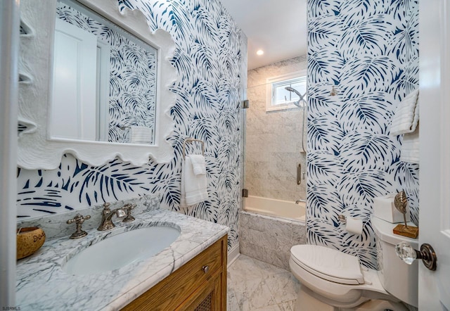 full bathroom with toilet, vanity, and tiled shower / bath