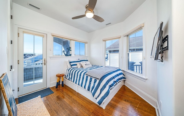 bedroom featuring ceiling fan, dark wood-type flooring, and access to outside