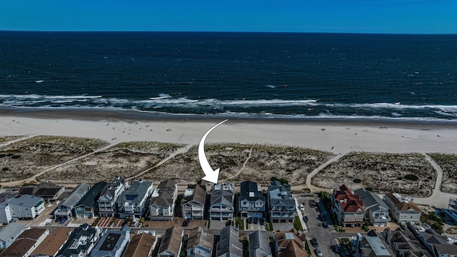 aerial view with a water view and a beach view