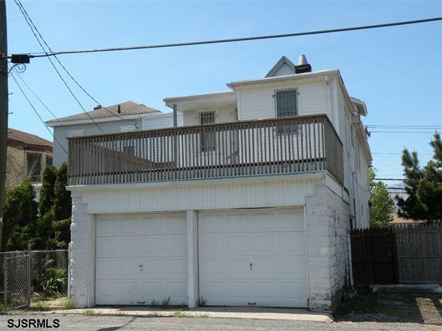 view of front property with a garage and a balcony