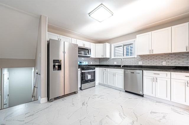 kitchen with sink, white cabinets, tasteful backsplash, and stainless steel appliances