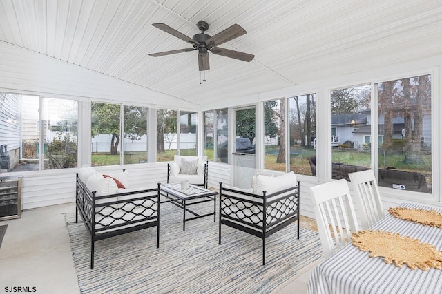 sunroom featuring lofted ceiling and ceiling fan