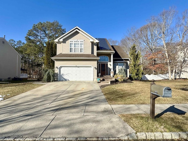 view of property with a front lawn and a garage