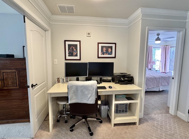 carpeted home office featuring crown molding