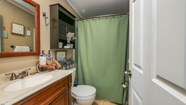 bathroom featuring toilet, vanity, and tile patterned flooring