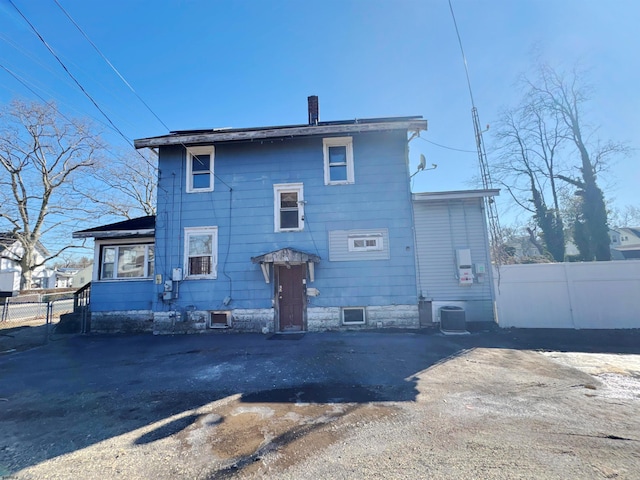 115 W Delilah Rd, Pleasantville, NJ 08232 - rear view of house featuring cooling unit, fence, and a chimney