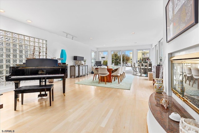 interior space featuring rail lighting, recessed lighting, and light wood-style floors