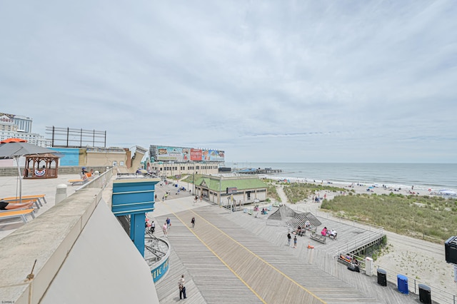 bird's eye view featuring a water view and a beach view