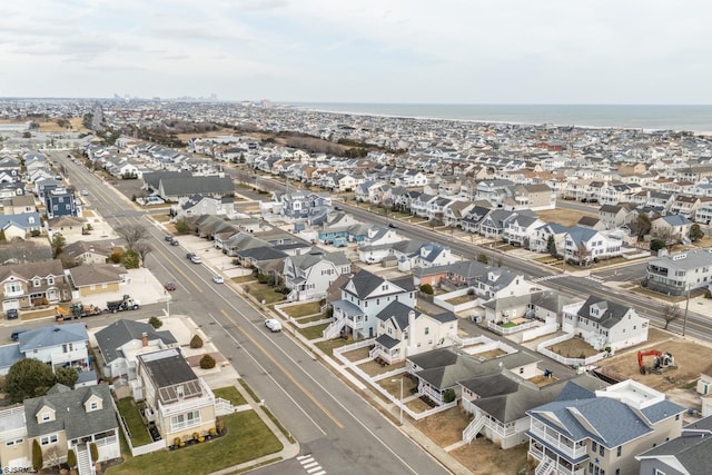 bird's eye view featuring a water view and a residential view