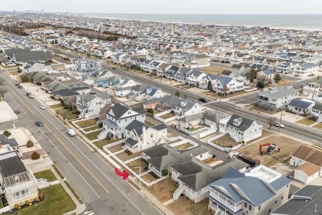 drone / aerial view with a water view and a residential view