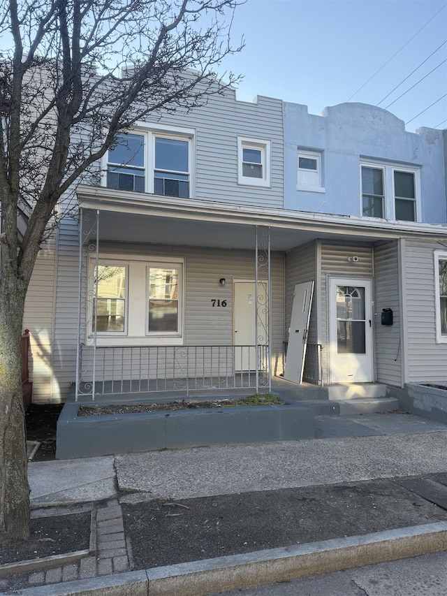 view of property featuring covered porch