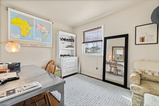 home office with baseboards and wood finished floors