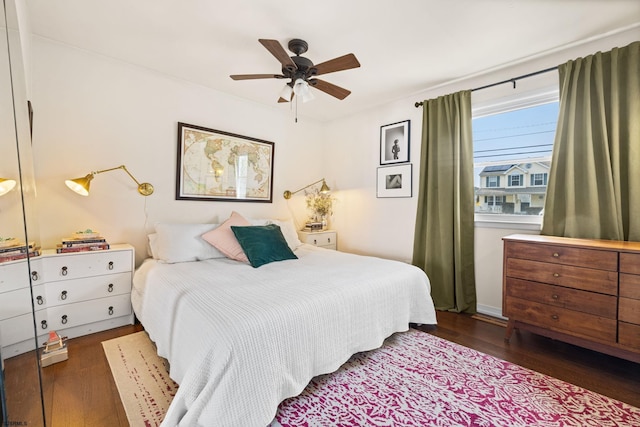 bedroom with ceiling fan and dark wood-type flooring