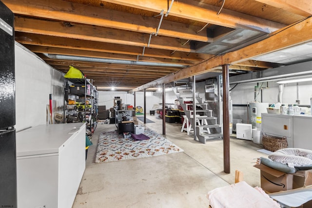 unfinished basement with water heater and washer and dryer