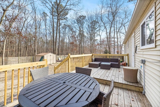 wooden terrace with a storage unit, an outdoor hangout area, outdoor dining space, a fenced backyard, and an outdoor structure