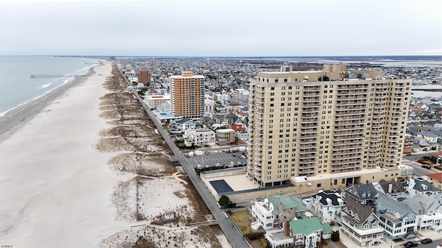 birds eye view of property with a beach view, a water view, and a city view