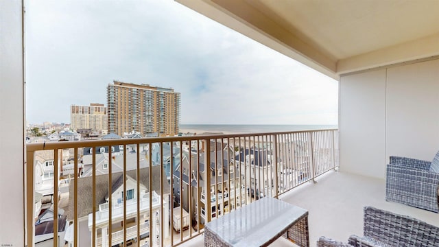 balcony featuring a view of city and a water view