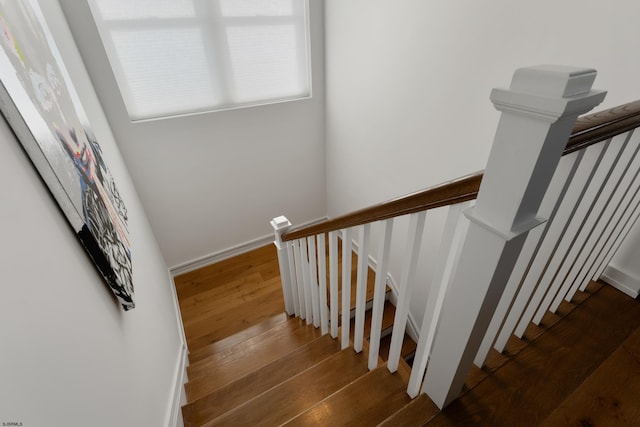 stairs with baseboards and wood finished floors