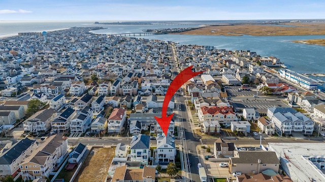 bird's eye view featuring a water view and a residential view