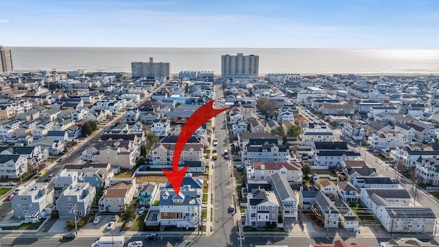 birds eye view of property featuring a view of city and a water view