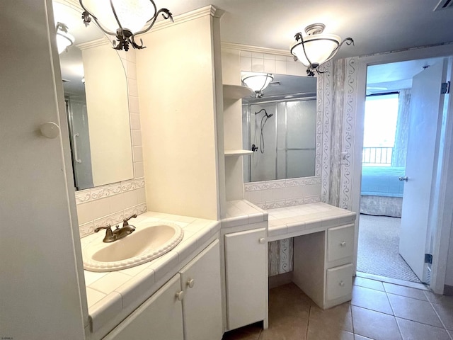 bathroom featuring tile patterned floors, a shower, and vanity