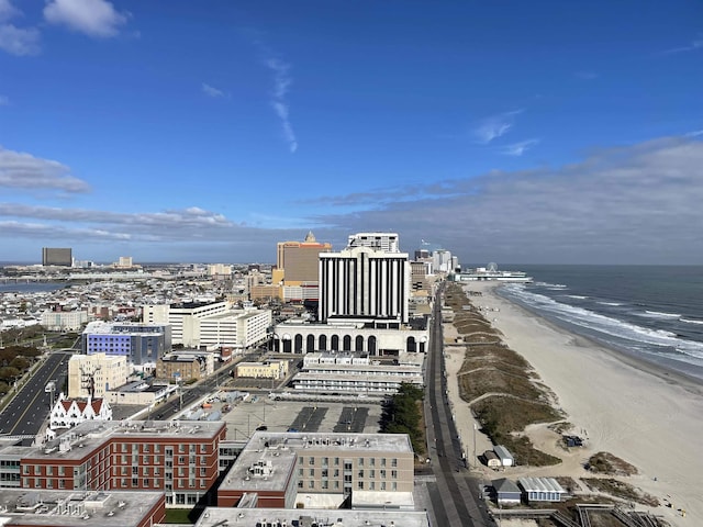 drone / aerial view with a view of city, a water view, and a view of the beach