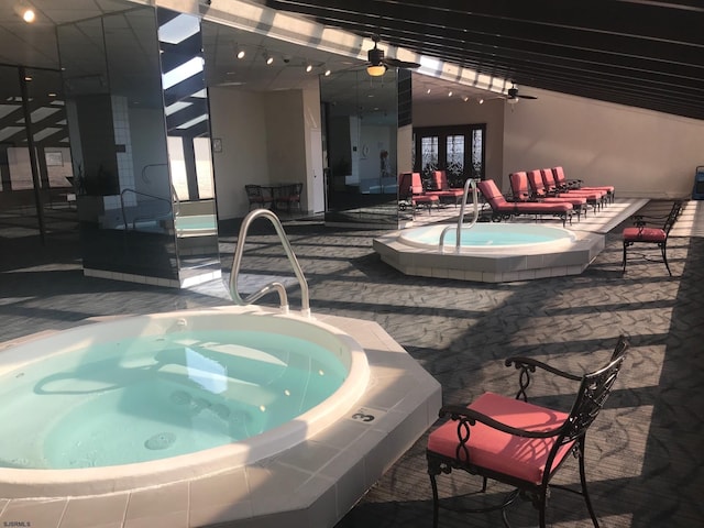 view of pool featuring ceiling fan, a community hot tub, and a patio